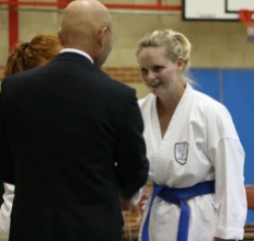 2009 Shikukai Championships Swindon. Teresa Allen of Chelmsford is congratulated for her 2nd place in the ladies junior grade kumite by Sugasawa Sensei.